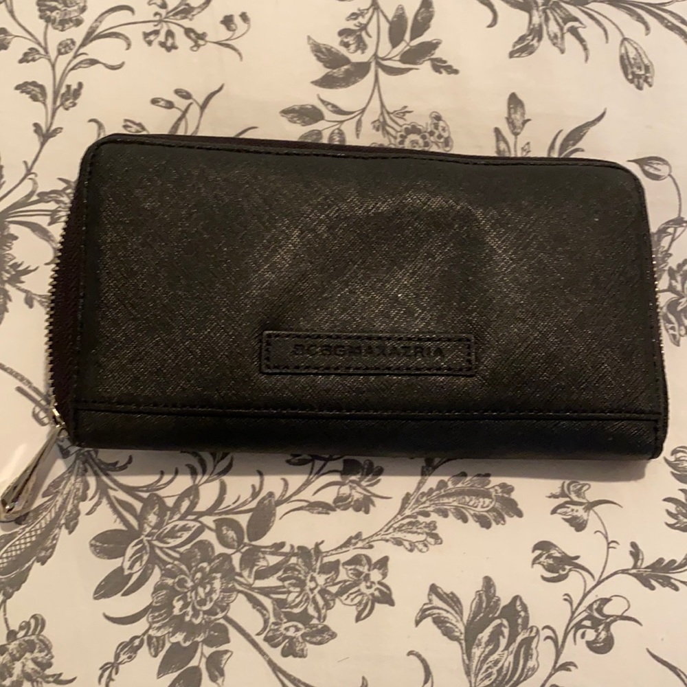 Gently used BCBG wallet in black with pink inside